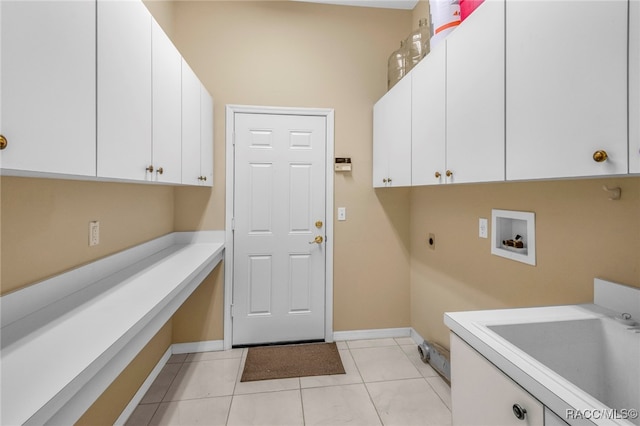 laundry area with cabinets, washer hookup, electric dryer hookup, sink, and light tile patterned floors