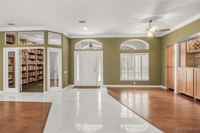 tiled foyer with ornamental molding