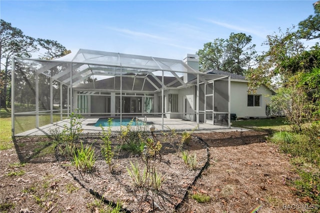 rear view of property with a patio area and a lanai