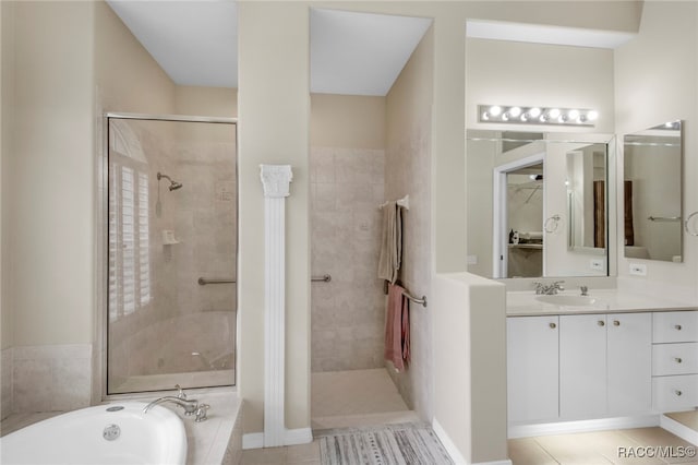 bathroom featuring tile patterned flooring, vanity, and plus walk in shower