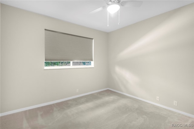 unfurnished room featuring ceiling fan and light colored carpet