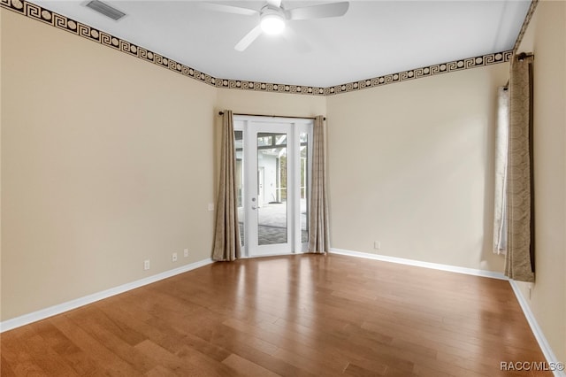 empty room featuring ceiling fan and wood-type flooring