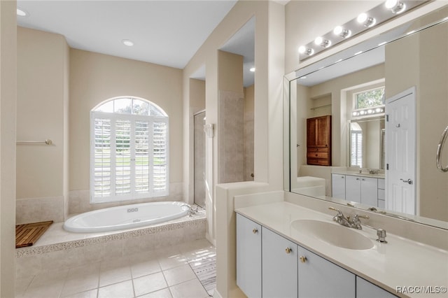 bathroom featuring tile patterned floors, vanity, and independent shower and bath