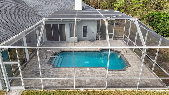 view of pool with a patio area and a lanai