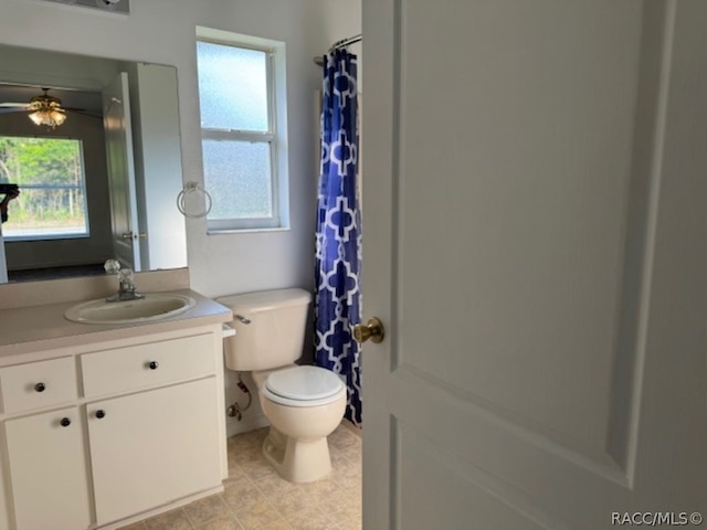 bathroom featuring vanity, toilet, and ceiling fan