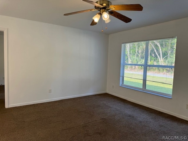 carpeted empty room featuring ceiling fan