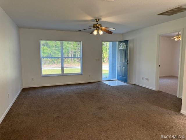 carpeted empty room featuring ceiling fan