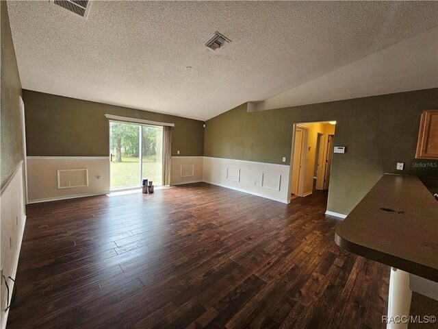 kitchen with exhaust hood, light brown cabinetry, and black appliances