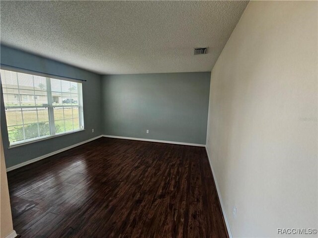 dining area featuring dark hardwood / wood-style floors and a textured ceiling