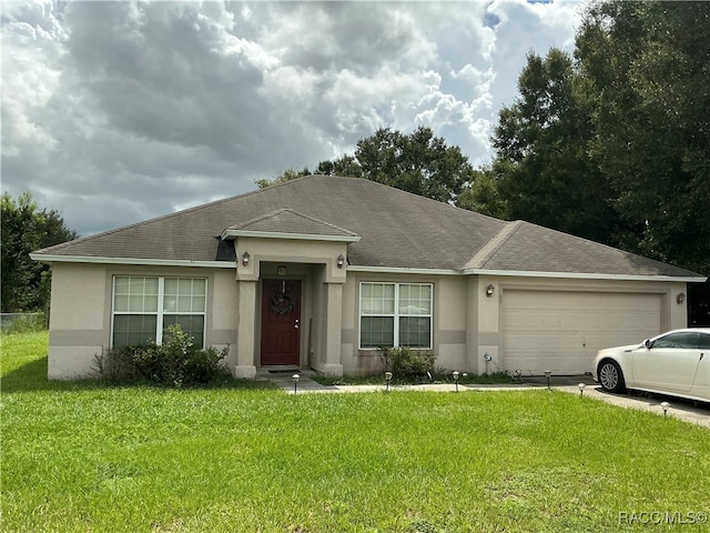 single story home featuring a garage and a front lawn