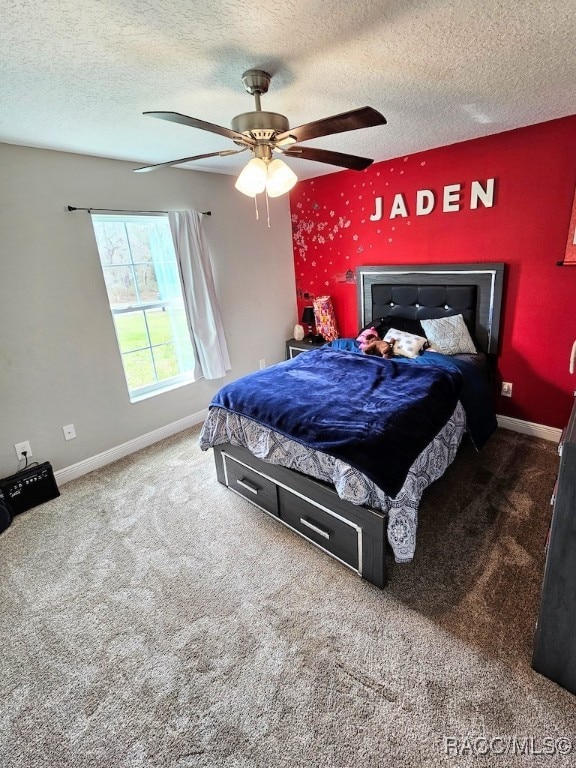 carpeted bedroom with ceiling fan and a textured ceiling