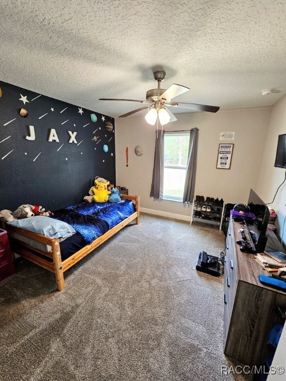 carpeted bedroom featuring ceiling fan and a textured ceiling