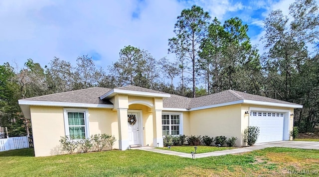 view of front of home featuring a garage and a front lawn