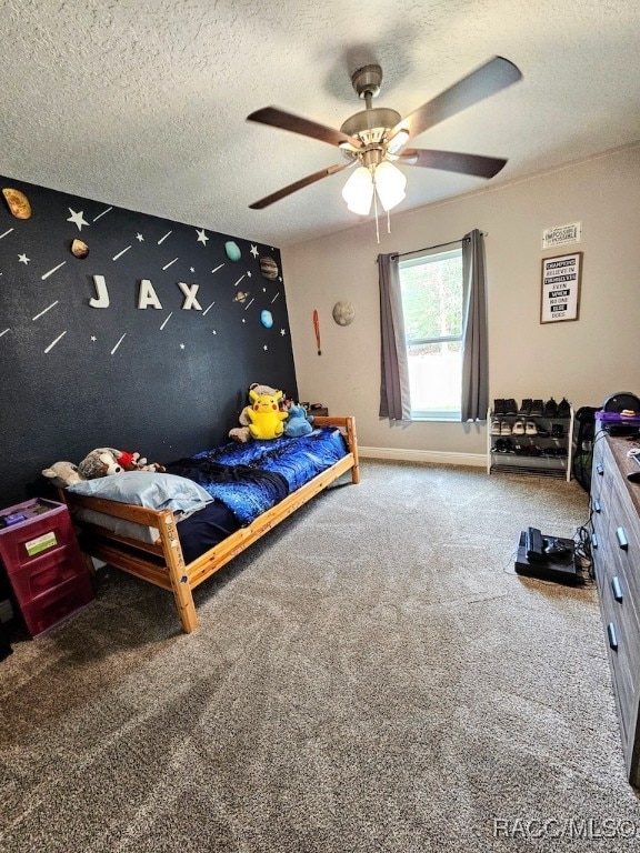 bedroom featuring carpet, ceiling fan, and a textured ceiling