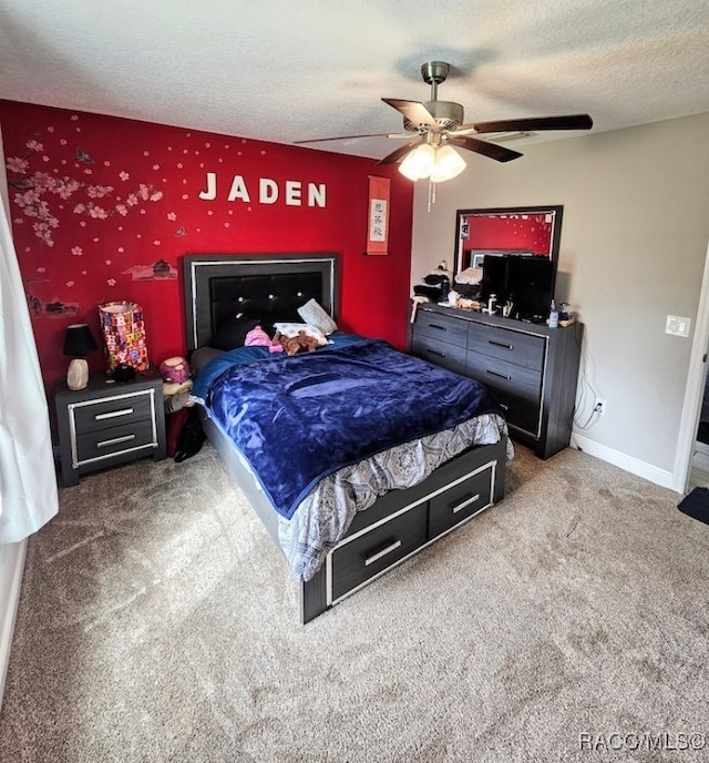 carpeted bedroom with a textured ceiling and ceiling fan