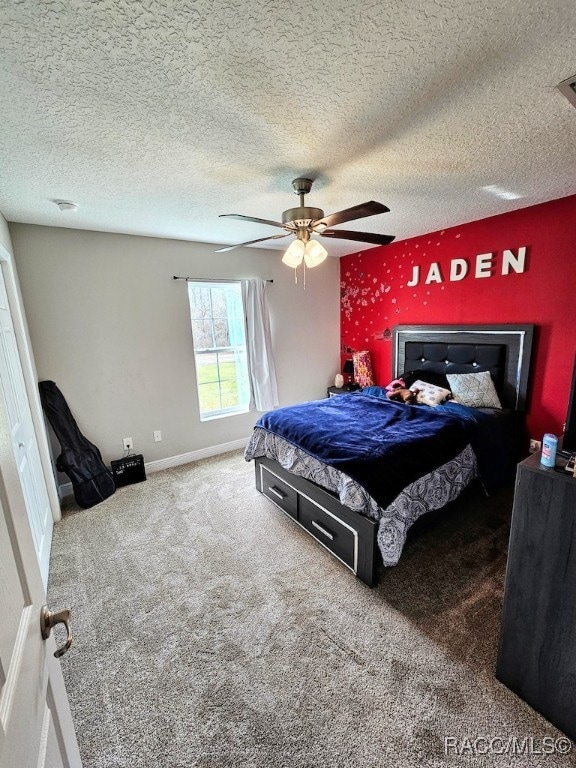 bedroom featuring carpet, a textured ceiling, and ceiling fan