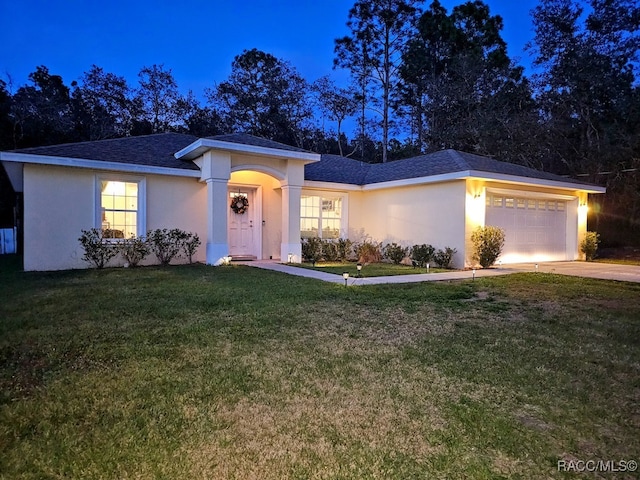 ranch-style home featuring a front lawn and a garage