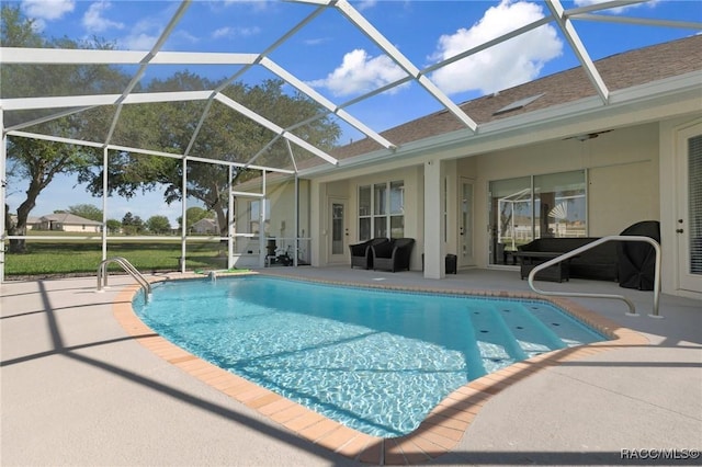 pool featuring a lanai and a patio area