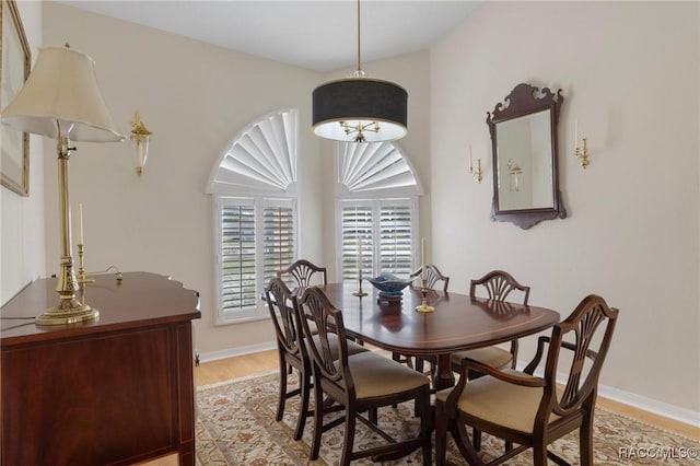 dining area featuring light wood-style floors and baseboards