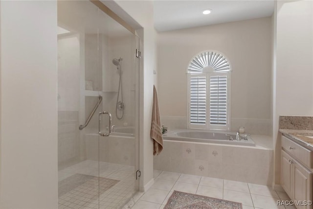 full bathroom with tile patterned floors, a shower stall, vanity, and a garden tub