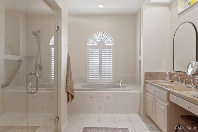 bathroom with tile patterned floors, a shower stall, vanity, and a garden tub