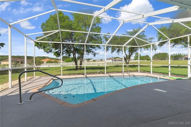 outdoor pool featuring fence, a patio, and a lanai