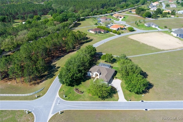 drone / aerial view with a forest view and a residential view