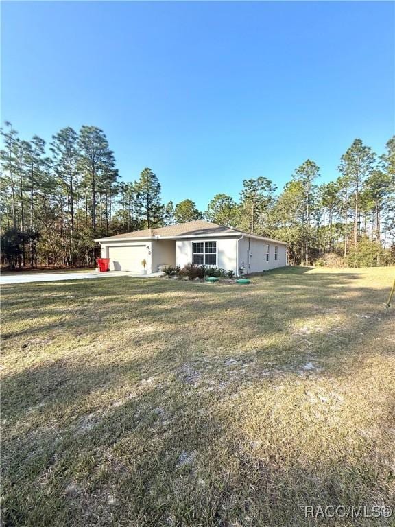 single story home with a garage and a front yard