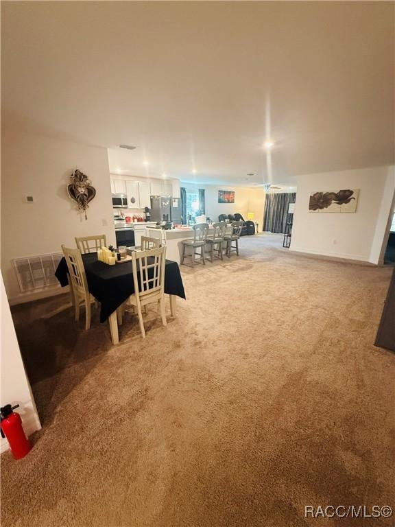 interior space featuring light colored carpet