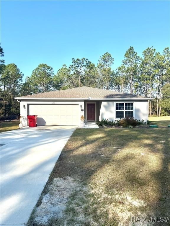 ranch-style house featuring a garage and a front yard