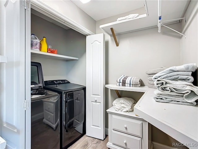 laundry area with laundry area, light wood finished floors, and independent washer and dryer