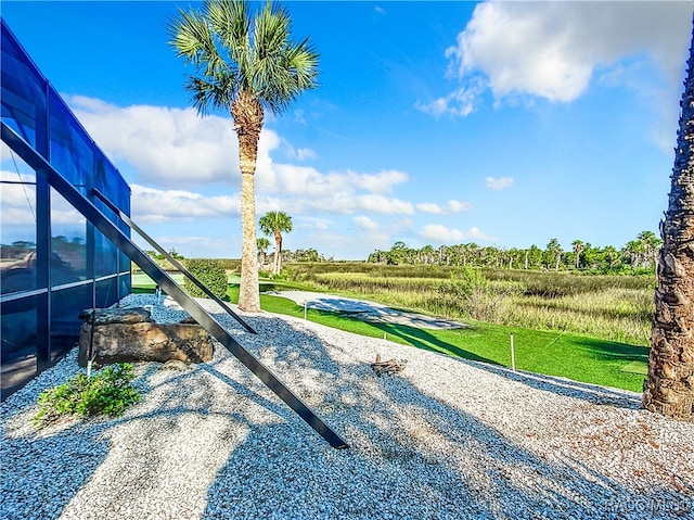 surrounding community with a rural view and a lawn