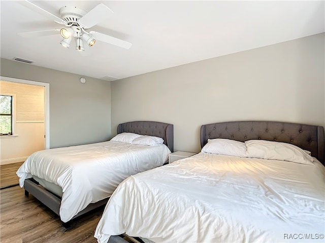 bedroom with ceiling fan and hardwood / wood-style flooring