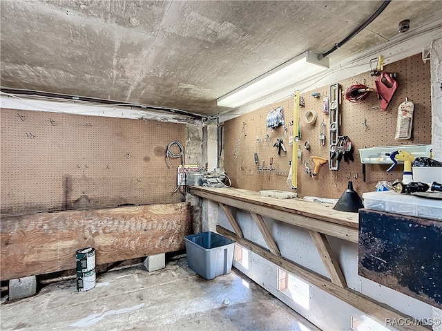 miscellaneous room featuring concrete flooring and a workshop area