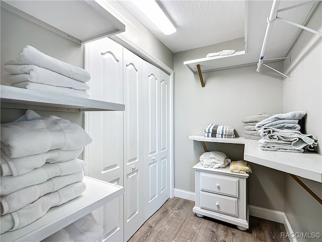 mudroom featuring wood-type flooring and a textured ceiling