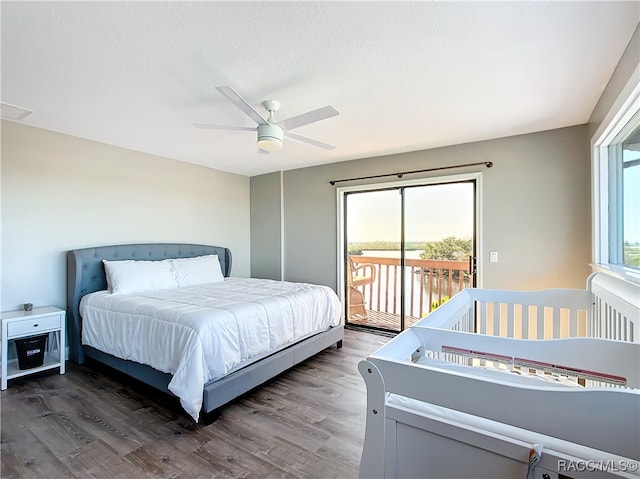 bedroom featuring dark wood-style floors, ceiling fan, visible vents, and access to exterior