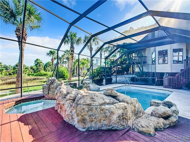 view of pool featuring a lanai and a jacuzzi