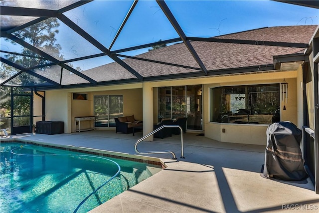 view of swimming pool with a lanai, outdoor lounge area, and a patio area