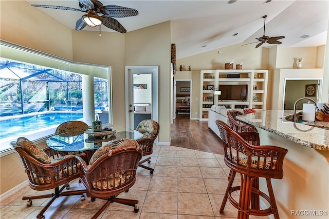 dining space with ceiling fan, plenty of natural light, and light tile patterned flooring