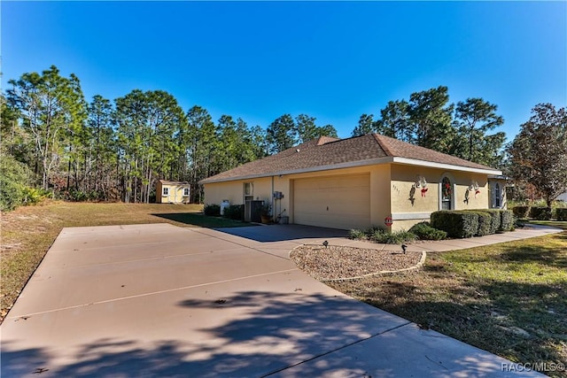 view of side of home with a yard and a garage