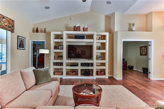 living room featuring a textured ceiling, vaulted ceiling, and hardwood / wood-style flooring