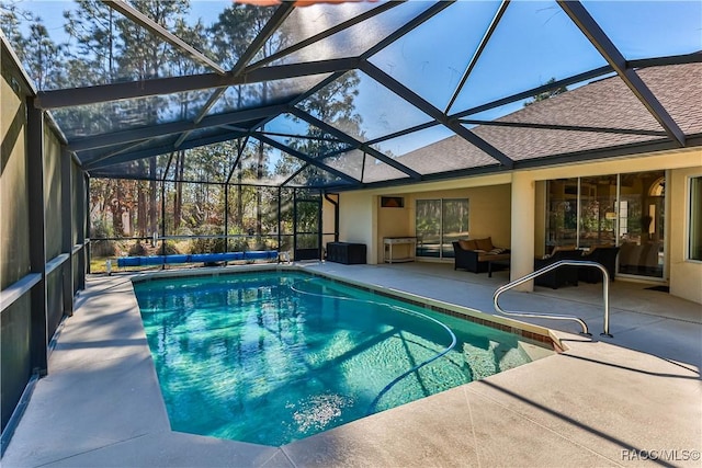 view of pool featuring an outdoor living space, glass enclosure, and a patio area