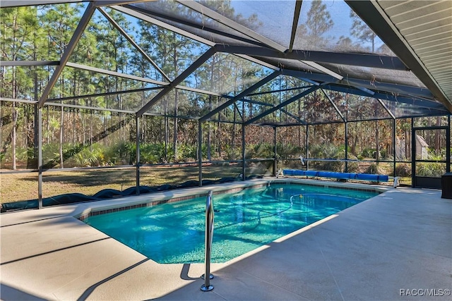 view of swimming pool with a patio area and glass enclosure