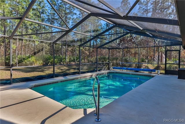 view of pool with a patio and a lanai