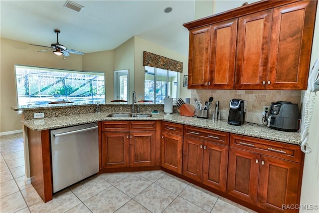 kitchen featuring light stone countertops, stainless steel dishwasher, a wealth of natural light, ceiling fan, and sink