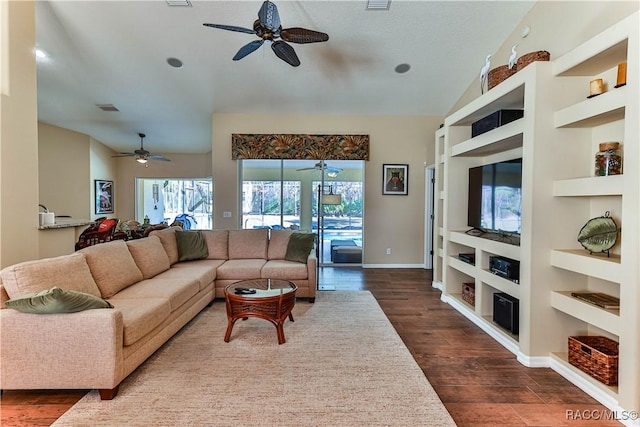 living room featuring dark hardwood / wood-style flooring, built in features, and ceiling fan