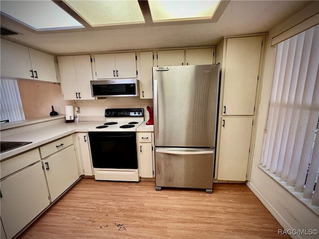 kitchen featuring white cabinetry, light hardwood / wood-style flooring, and stainless steel appliances