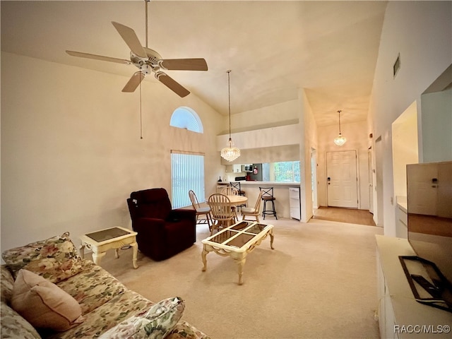 carpeted living room featuring a wealth of natural light, ceiling fan, and high vaulted ceiling