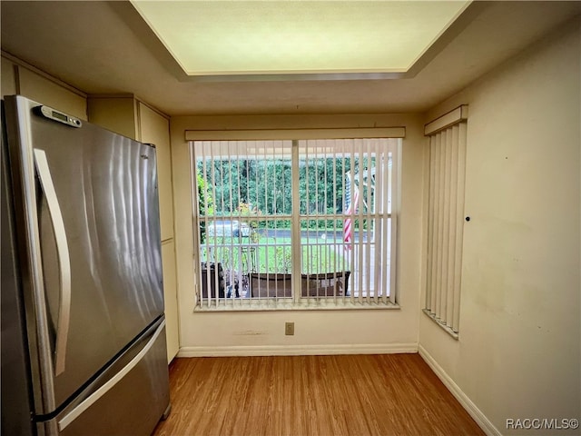 interior space featuring stainless steel fridge and light wood-type flooring