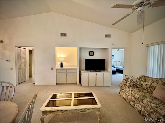 living room featuring light carpet and high vaulted ceiling